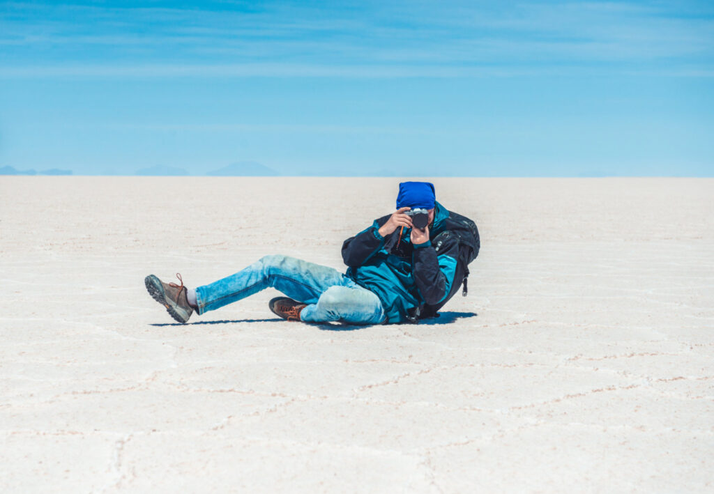 Photographer came down to take photo in sunshine Salar de Uyuni